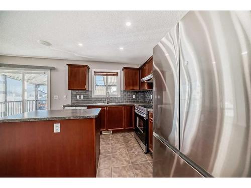 100 Covepark Rise Ne, Calgary, AB - Indoor Photo Showing Kitchen With Double Sink