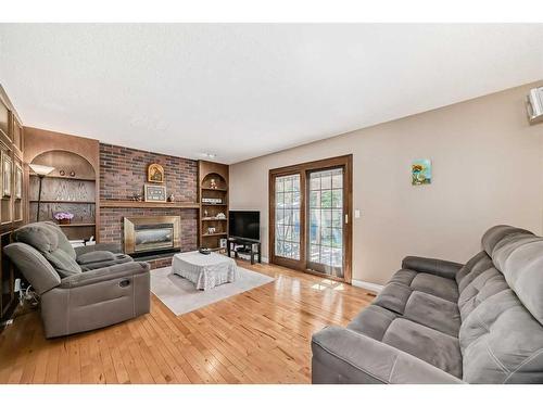 47 Woodmont Drive Sw, Calgary, AB - Indoor Photo Showing Living Room With Fireplace