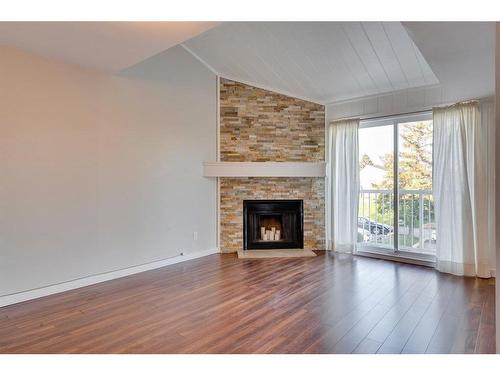 306-13104 Elbow Drive Sw, Calgary, AB - Indoor Photo Showing Living Room With Fireplace