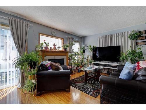 211 Millview Green Sw, Calgary, AB - Indoor Photo Showing Living Room With Fireplace