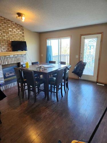 271236 Range Road 13 Nw, Airdrie, AB - Indoor Photo Showing Dining Room With Fireplace