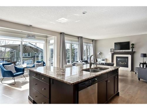 19 Auburn Sound Cove Se, Calgary, AB - Indoor Photo Showing Kitchen With Fireplace With Double Sink