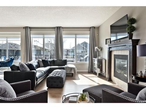 19 Auburn Sound Cove Se, Calgary, AB - Indoor Photo Showing Living Room With Fireplace