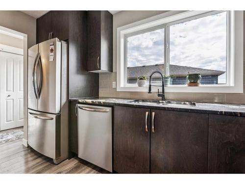 104 Legacy View Se, Calgary, AB - Indoor Photo Showing Kitchen With Stainless Steel Kitchen With Double Sink
