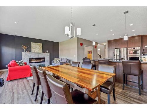 12 Legacy Court Se, Calgary, AB - Indoor Photo Showing Dining Room With Fireplace