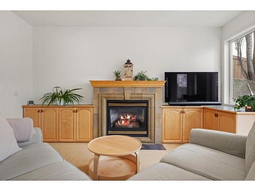 432 Rocky Ridge Cove Nw, Calgary, AB - Indoor Photo Showing Living Room With Fireplace
