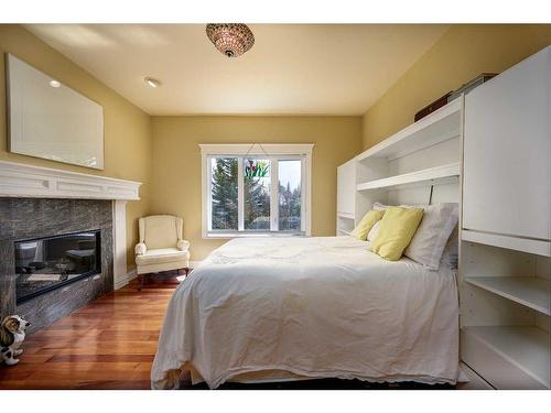 328 Signature Court Sw, Calgary, AB - Indoor Photo Showing Bedroom With Fireplace