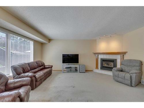 252 Edgebrook Gardens Nw, Calgary, AB - Indoor Photo Showing Living Room With Fireplace