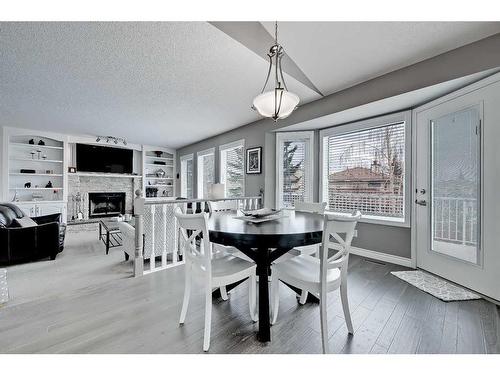 136 Hawkdale Close Nw, Calgary, AB - Indoor Photo Showing Dining Room With Fireplace