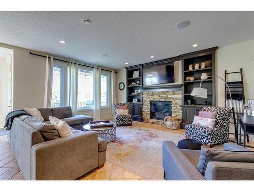 15 Crestridge Point Sw, Calgary, AB - Indoor Photo Showing Living Room With Fireplace