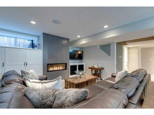17 Drake Landing Loop, Okotoks, AB - Indoor Photo Showing Living Room With Fireplace