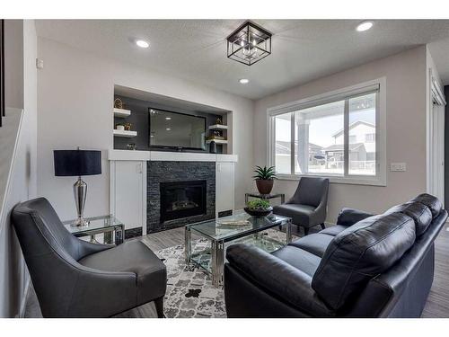 4231 63 Avenue, Innisfail, AB - Indoor Photo Showing Living Room With Fireplace