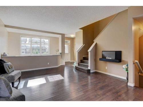 108 New Brighton Grove Se, Calgary, AB - Indoor Photo Showing Living Room With Fireplace