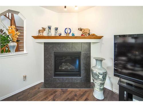 245 Silverado Way Sw, Calgary, AB - Indoor Photo Showing Living Room With Fireplace