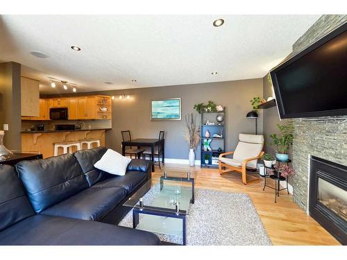 185-87 Glamis Green Sw, Calgary, AB - Indoor Photo Showing Living Room With Fireplace