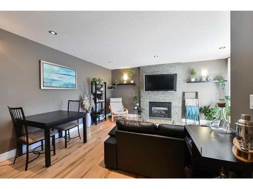 185-87 Glamis Green Sw, Calgary, AB - Indoor With Fireplace