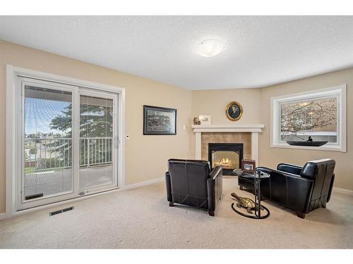 176 Strathaven Circle Sw, Calgary, AB - Indoor With Fireplace