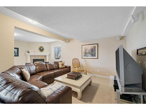 176 Strathaven Circle Sw, Calgary, AB - Indoor Photo Showing Living Room With Fireplace