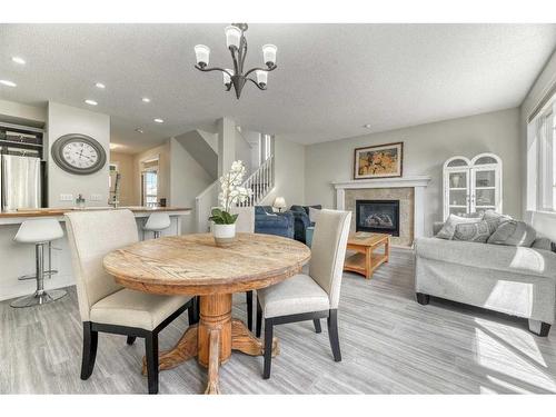 48 Prestwick Estate Way Se, Calgary, AB - Indoor Photo Showing Dining Room With Fireplace
