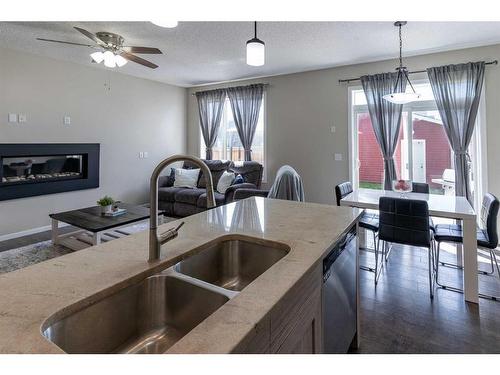 1757 Baywater Road Sw, Airdrie, AB - Indoor Photo Showing Kitchen With Fireplace With Double Sink