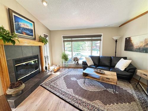 85 Manyhorses Drive, Rural Rocky View County, AB - Indoor Photo Showing Living Room With Fireplace