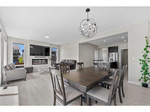 9 Corner Meadows Grove Ne, Calgary, AB - Indoor Photo Showing Dining Room With Fireplace