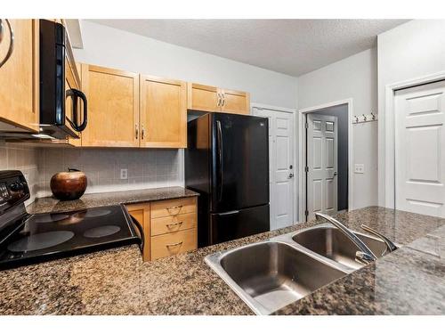 103-5720 2 Street Sw, Calgary, AB - Indoor Photo Showing Kitchen With Double Sink