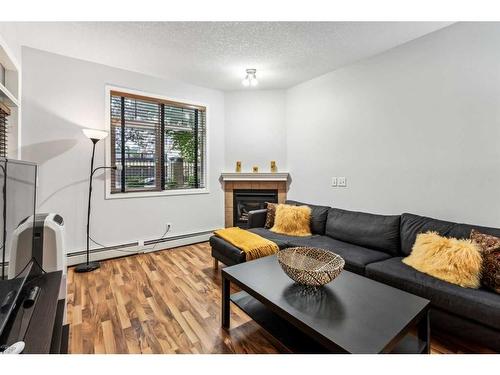 103-5720 2 Street Sw, Calgary, AB - Indoor Photo Showing Living Room With Fireplace