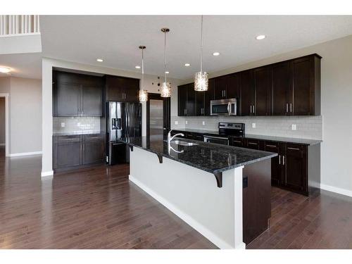 209 Kingsmere Cove Se, Airdrie, AB - Indoor Photo Showing Kitchen With Double Sink With Upgraded Kitchen