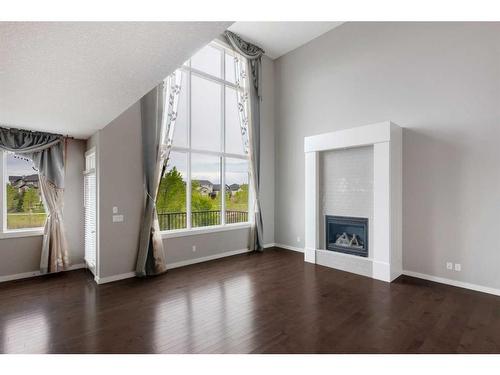 209 Kingsmere Cove Se, Airdrie, AB - Indoor Photo Showing Living Room With Fireplace