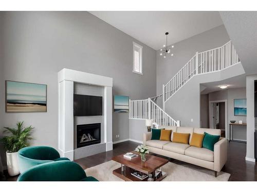 209 Kingsmere Cove Se, Airdrie, AB - Indoor Photo Showing Living Room With Fireplace