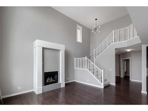 209 Kingsmere Cove Se, Airdrie, AB - Indoor Photo Showing Other Room With Fireplace