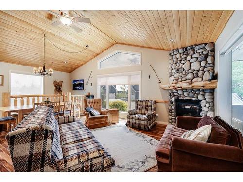 4031-25054 South Pine Lake Road, Rural Red Deer County, AB - Indoor Photo Showing Living Room With Fireplace