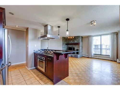 604-215 14 Avenue Sw, Calgary, AB - Indoor Photo Showing Kitchen With Fireplace