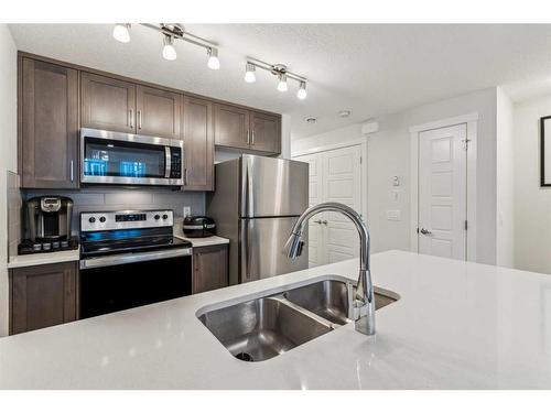 507-338 Seton Circle Se, Calgary, AB - Indoor Photo Showing Kitchen With Stainless Steel Kitchen With Double Sink