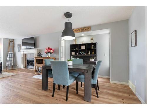 182 Cranberry Close Se, Calgary, AB - Indoor Photo Showing Dining Room With Fireplace