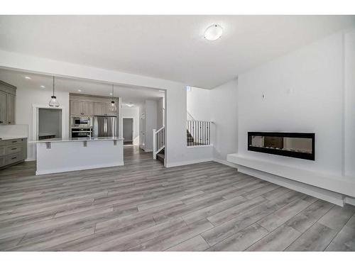 693 Creekmill Court Sw, Airdrie, AB - Indoor Photo Showing Living Room With Fireplace