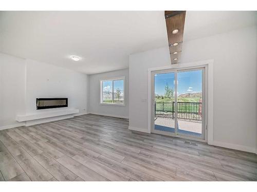 693 Creekmill Court Sw, Airdrie, AB - Indoor Photo Showing Living Room With Fireplace