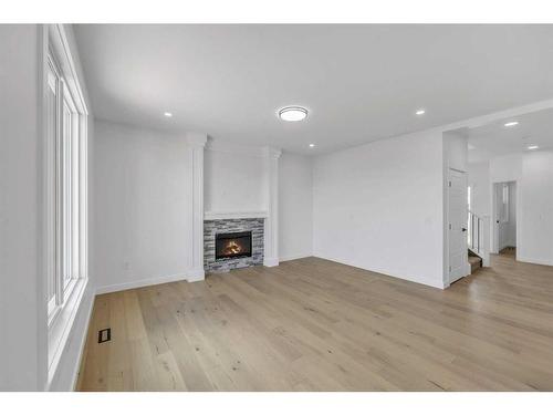 122 Baysprings Gardens, Airdrie, AB - Indoor Photo Showing Other Room With Fireplace