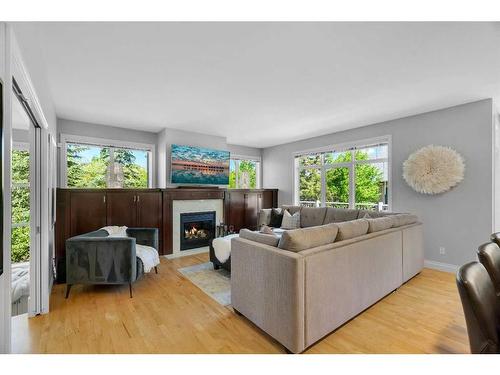 8 Discovery Valley Cove Sw, Calgary, AB - Indoor Photo Showing Living Room With Fireplace