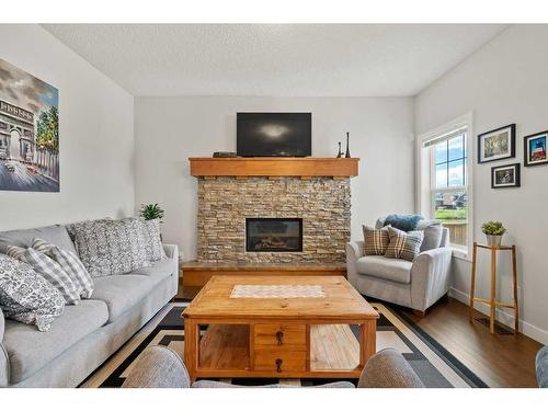 130 Reunion Landing Nw, Airdrie, AB - Indoor Photo Showing Living Room With Fireplace