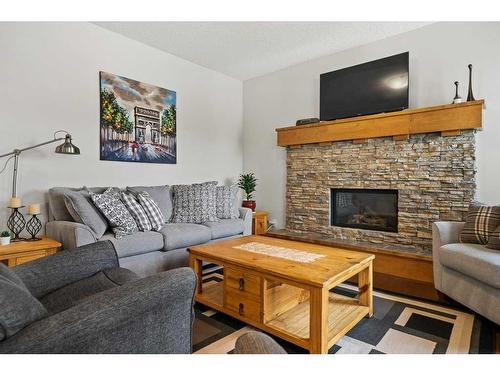 130 Reunion Landing Nw, Airdrie, AB - Indoor Photo Showing Living Room With Fireplace