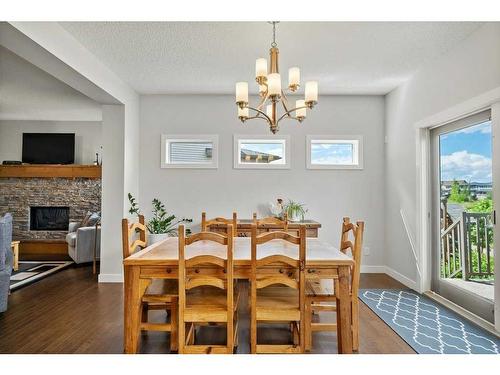 130 Reunion Landing Nw, Airdrie, AB - Indoor Photo Showing Dining Room With Fireplace