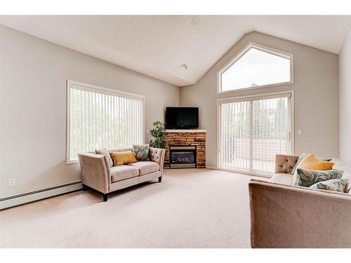 2312-7451 Springbank Boulevard Sw, Calgary, AB - Indoor Photo Showing Living Room With Fireplace