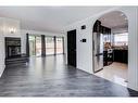 503-5660 23 Avenue Ne, Calgary, AB  - Indoor Photo Showing Living Room With Fireplace 