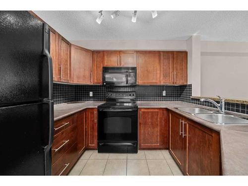 2113-16969 24 Street Sw, Calgary, AB - Indoor Photo Showing Kitchen With Double Sink