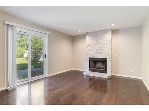 132 Millpark Road Sw, Calgary, AB - Indoor Photo Showing Living Room With Fireplace