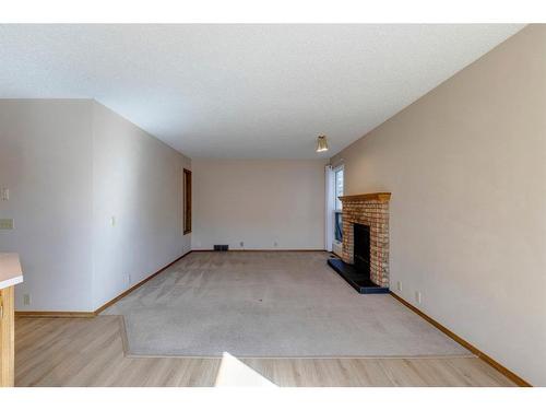 17 Sundown Close Se, Calgary, AB - Indoor Photo Showing Other Room With Fireplace