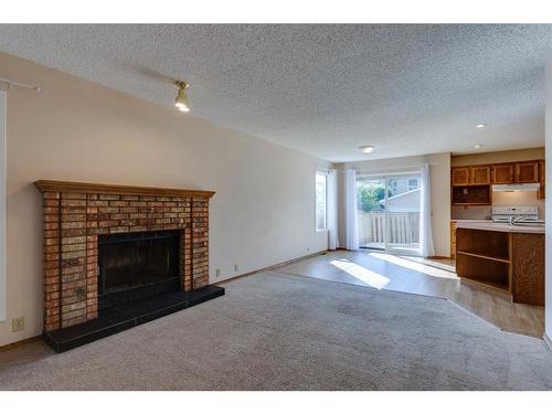 17 Sundown Close Se, Calgary, AB - Indoor Photo Showing Living Room With Fireplace