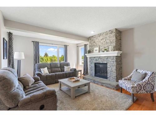 626 Hidden Vale Place Nw, Calgary, AB - Indoor Photo Showing Living Room With Fireplace